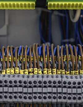 Electrical panel with fuses and contactors, close-up. Voltage distributor with automatic switches. Electrical background.